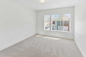 Empty room featuring baseboards, carpet, and visible vents