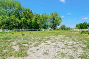 View of yard featuring fence and a rural view