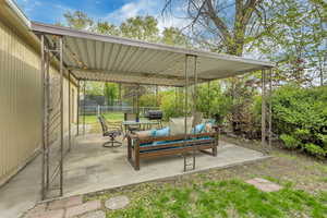 View of covered patio with fence