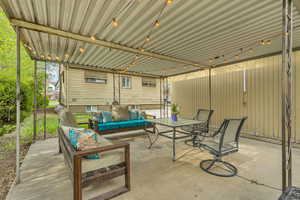 View of patio with an outdoor hangout area