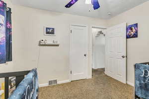 Bedroom featuring visible vents, baseboards, carpet floors, and ceiling fan