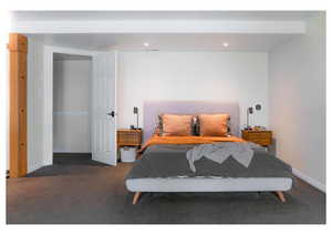 Carpeted bedroom with baseboards and recessed lighting