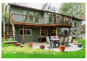 Back of property featuring a patio, a deck, and stairway