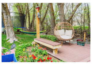Deck with a trampoline and a yard