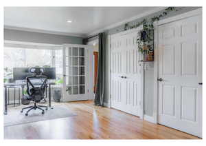 Office space with ornamental molding, recessed lighting, and wood finished floors