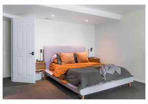 Carpeted bedroom with recessed lighting, baseboards, and visible vents