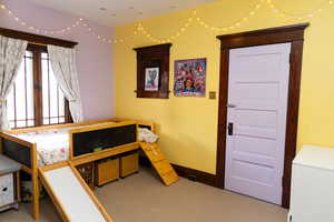 Carpeted bedroom with baseboards