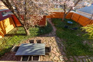 View of yard featuring outdoor dining area and a fenced backyard