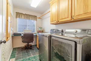 Laundry area featuring visible vents, cabinet space, baseboards, and washer and clothes dryer