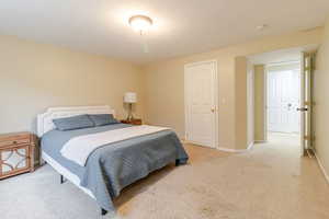 Carpeted bedroom with baseboards