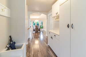 Hallway featuring dark wood-style floors and arched walkways