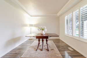 Office with crown molding, wood finished floors, and baseboards