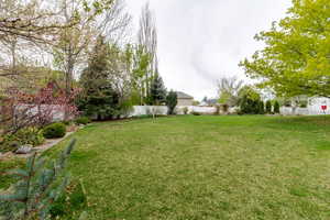 View of yard featuring fence