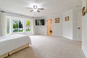 Bedroom with crown molding, a ceiling fan, and light colored carpet