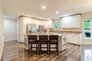 Kitchen featuring recessed lighting, appliances with stainless steel finishes, wood finished floors, and baseboards