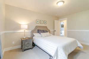 Bedroom with baseboards and carpet floors