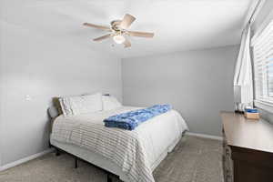 Bedroom featuring baseboards, carpet flooring, and ceiling fan