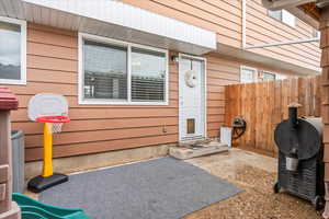 Property entrance featuring a patio and fence