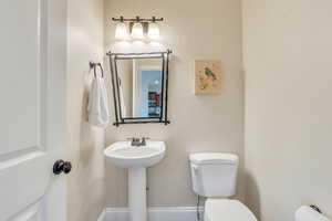 Half bathroom with toilet and a sink