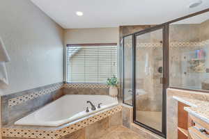 Master bath has walk-in shower and garden tub