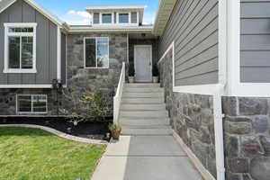 Entrance to property featuring board and batten siding and stone siding