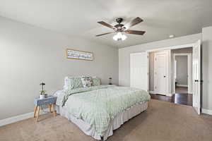 Primary Bedroom with carpet flooring, baseboards, and ceiling fan