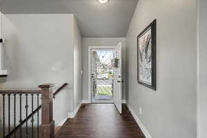 Foyer featuring baseboards and dark wood-style floors