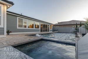 View of swimming pool with a fenced in pool, a fenced backyard, a patio area, and an in ground hot tub