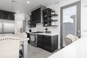 Kitchen featuring  open shelves, light countertops, and high quality appliances