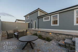 Lowered patio with outdoor lounge area and fence, custom lighting & dining bar to spa, tv hookups