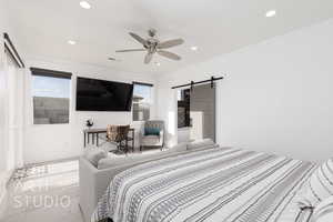 Primary Bedroom featuring recessed lighting, a barn door and sliding door to back patio/pool/spa area
