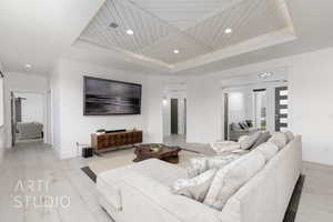 Living room featuring baseboards, recessed lighting, a tray ceiling, and wood ceiling