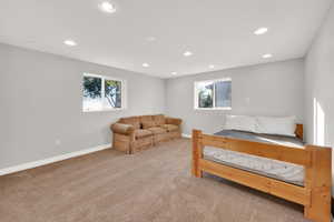 Bedroom with recessed lighting, baseboards, multiple windows, and carpet