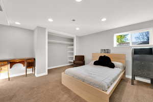 Carpeted bedroom featuring baseboards, a closet, and recessed lighting