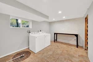 Washroom with laundry area, independent washer and dryer, a fireplace, recessed lighting, and light tile patterned flooring
