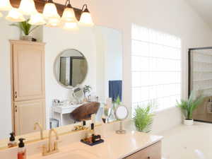 Full bathroom featuring a whirlpool tub, a shower stall, and vanity