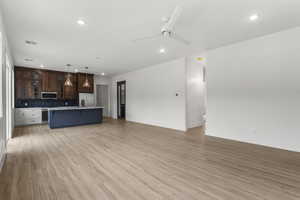 Unfurnished living room with recessed lighting, a ceiling fan, and light wood finished floors