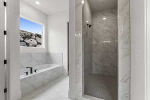 Bathroom with a bath, recessed lighting, a marble finish shower, and marble finish floor