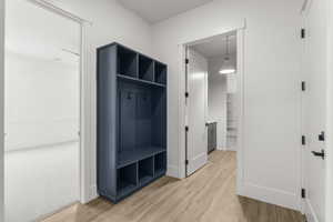 Mudroom with baseboards and light wood finished floors