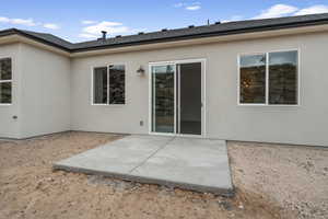 Back of house featuring a patio area and stucco siding