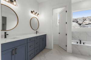 Full bathroom featuring a sink, baseboards, double vanity, and marble finish floor
