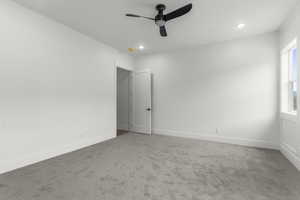 Carpeted spare room with baseboards, ceiling fan, and recessed lighting