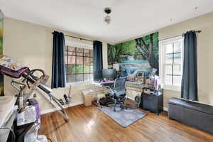 Office with baseboards, wood finished floors, and a wealth of natural light