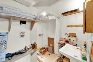 Full bath with a sink and a shower with shower curtain