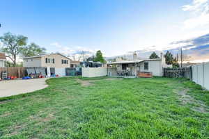 View of yard featuring a fenced backyard, a hot tub, and a patio area