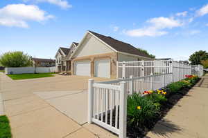 View of property exterior with brick siding, a garage, driveway,RV Pad and fence private yard