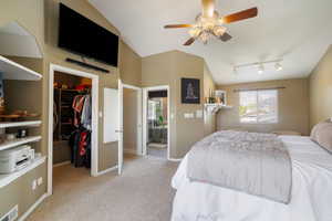 Carpeted bedroom featuring visible vents, a closet, baseboards, a walk in closet, and ceiling fan
