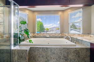 Bathroom featuring a garden tub and a stall shower