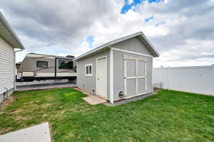 View of RV Pad, Shed with a Vinyl fenced backyard