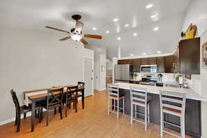 Kitchen featuring recessed lighting, a ceiling fan, stainless steel appliances, and a peninsula